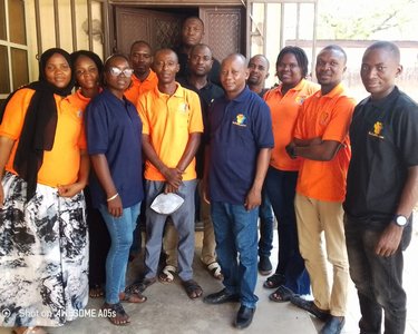 Participants gather with Dr. Sani Njobdi (center) after a training session.